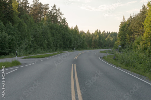 Empty road to Midsummer sunset sun