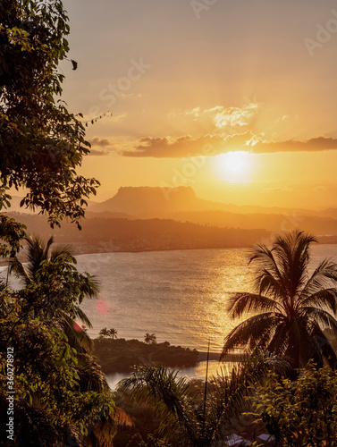 View over Bahia de Miel towards city and El Yunque Mountain, sunset, Baracoa, Guantanamo Province, Cuba photo