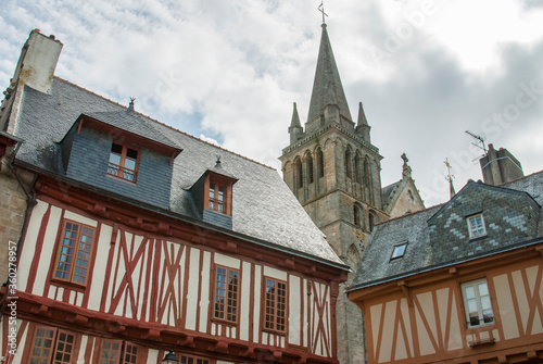 Vannes church tower photographed between two typical Breton houses