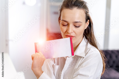 Girl with brochure at the reception. Customer in spa. Woman`s beauty concept. photo