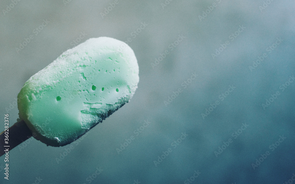 Close-up of green ice cream on stick Close-up of green ice cream on stick