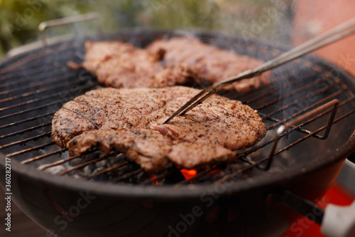 Close-up of steak being grilled on barbecue at patio photo