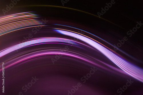 Full frame abstract image of purple light trails against black background photo