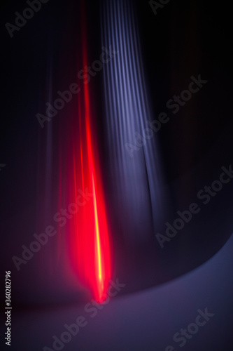 Abstract red and gray light trails against black background photo