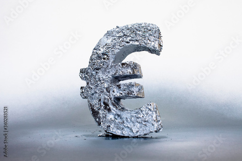 Close-up of silver Euro symbol against gray background