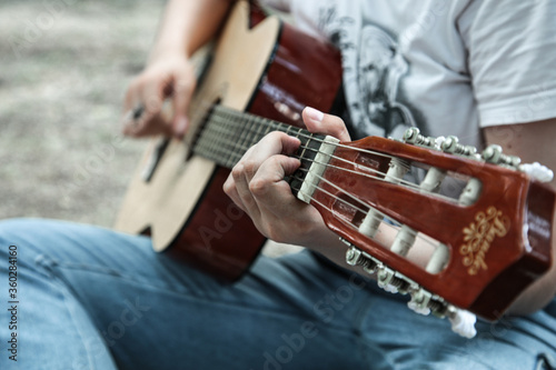 girl playing guitar close up