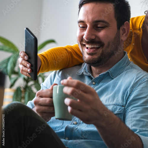 Smiling man looking at mobile phone stock photo