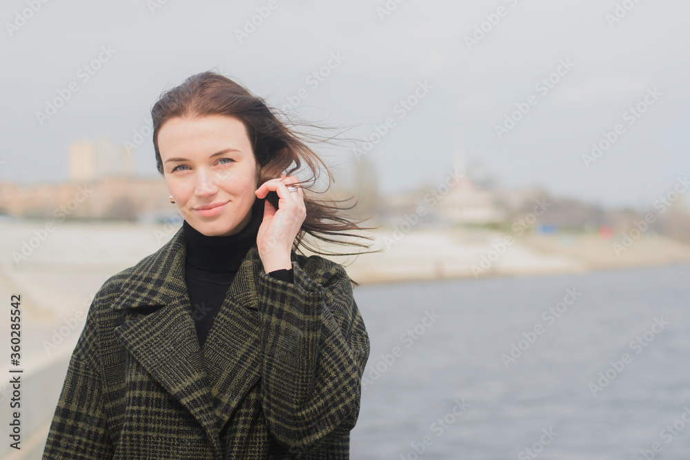 portrait of a brown-haired young girl walking along the city promenade portrait of a brown-haired young girl walking along the city promenade