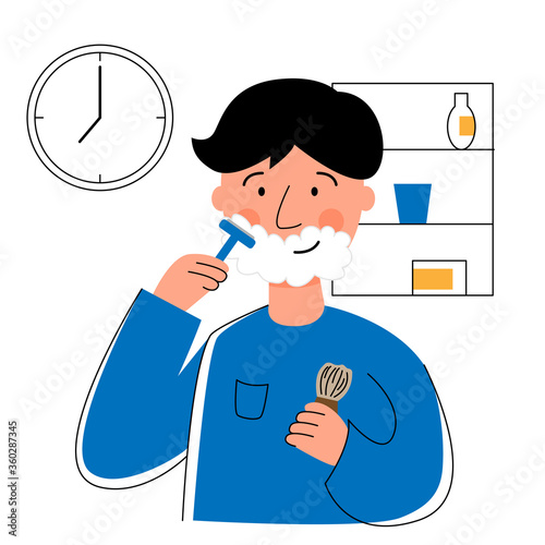 A man shaves his face in his bathroom. Morning hygiene.