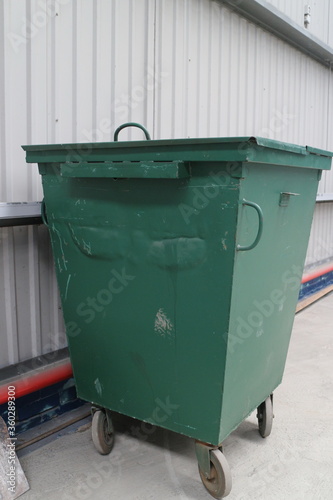 Green garbage bin in the hangar