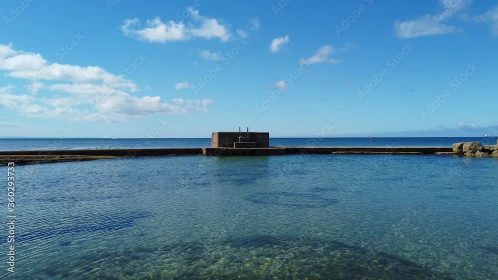 Oceanic pool with Crystal clear water with blue sky in background in a summer day Oceanic pool with Crystal clear water with blue sky in background in a summer day