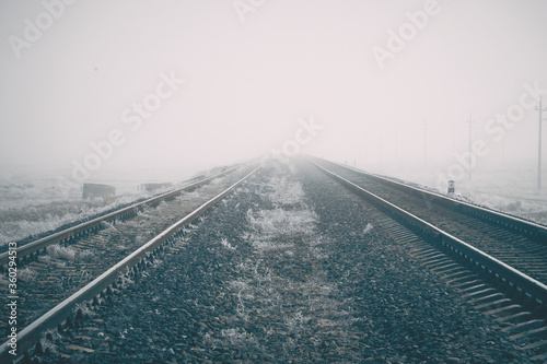 Railway to horizon in fog. High quality photo