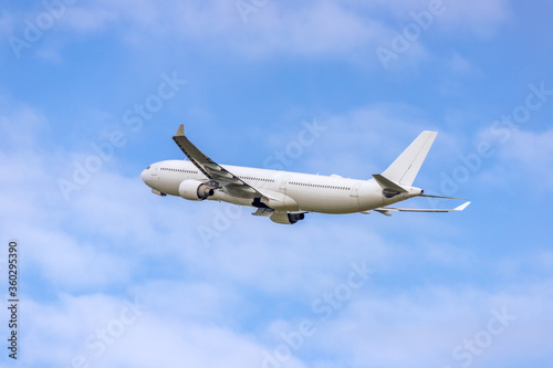 
Commercial wide-body airplane flying above a cloudscape
