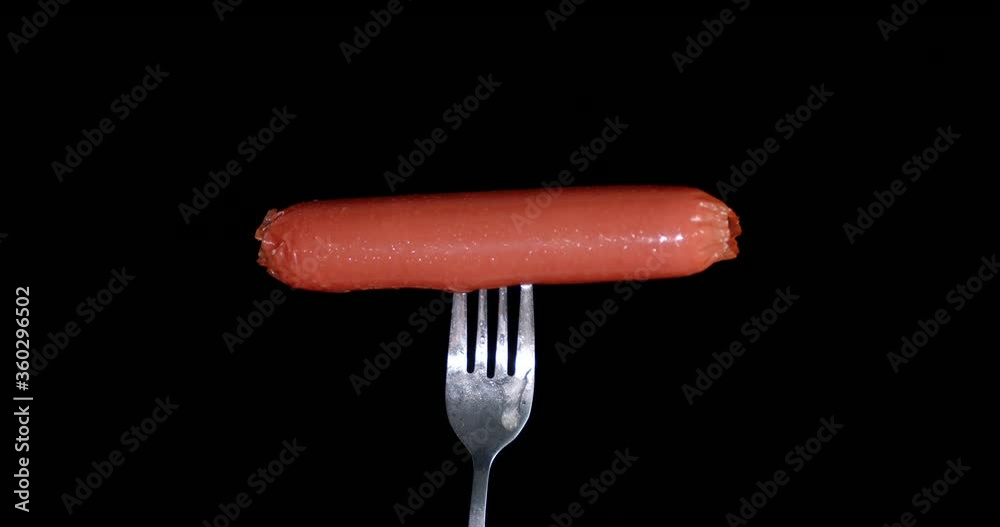 One boiled sausage on a fork. One boiled sausage on a fork.