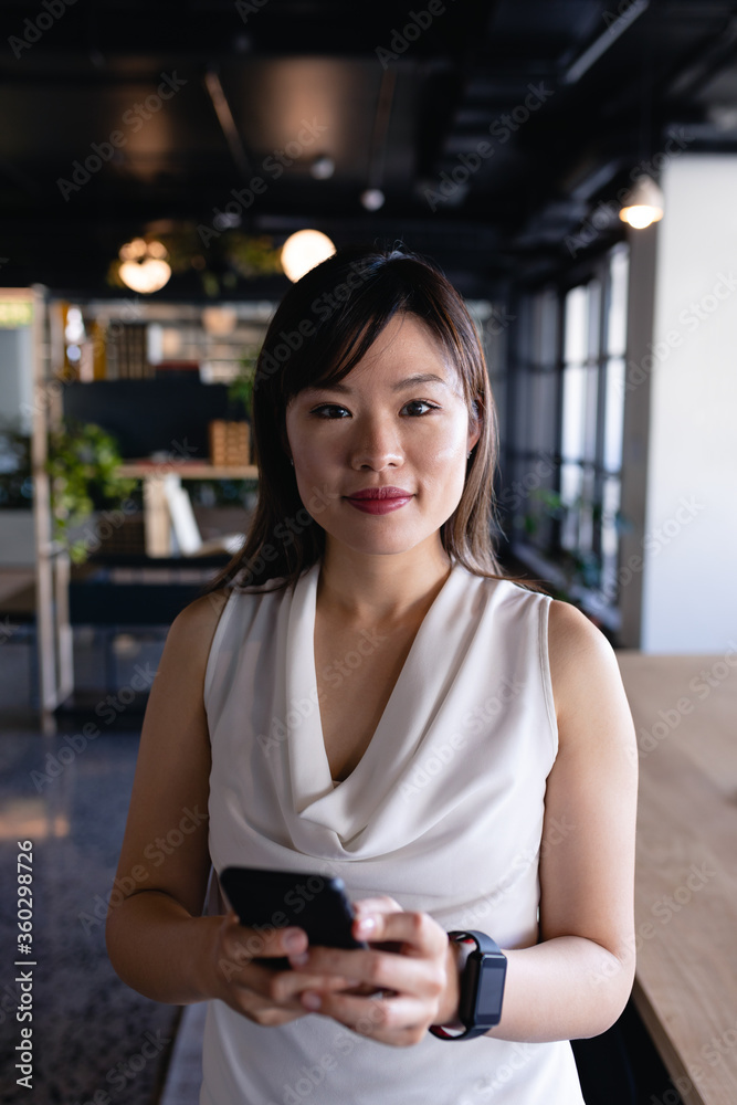 Asian woman using her phone and wearing digital watch Asian woman using her phone and wearing digital watch