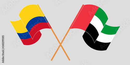 Crossed and waving flags of Colombia and the United Arab Emirates