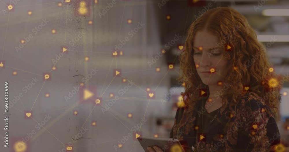Digital composite video of network of connection with interface icons against woman using tablet