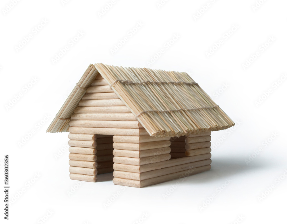 Miniature house, made of toothpicks and dry grass. Isolated on white background. Miniature house, made of toothpicks and dry grass. Isolated on white background.