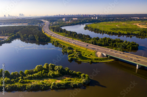 panoramic view of expressway across the river taken from a drone at dawn