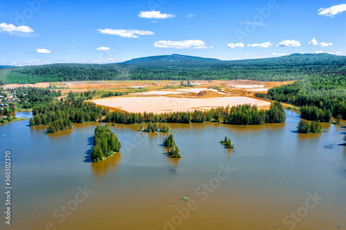 Aerial view of dumps and polluted ponds. Gold mining. Problem of environmental pollution