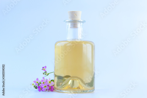 Essential oil of Arabis flower on a White background in beautiful bottle