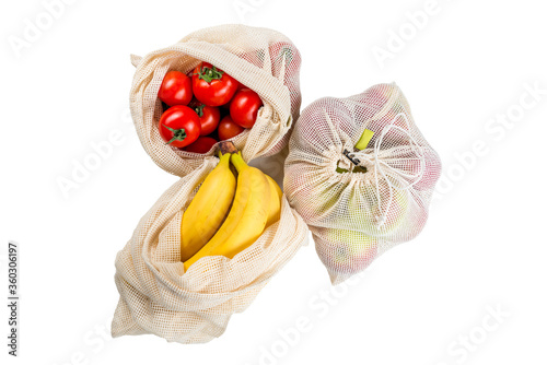 tomatoes, banana and apples in eco friendly mesh bags isolated, zero waste concept