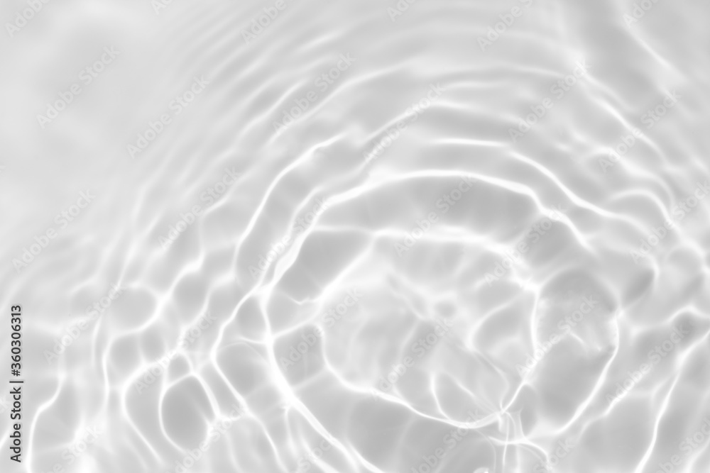 Closeup of desaturated transparent clear calm water surface texture with splashes and bubbles. Trendy abstract nature background. Closeup of desaturated transparent clear calm water surface texture with splashes and bubbles. Trendy abstract nature background.