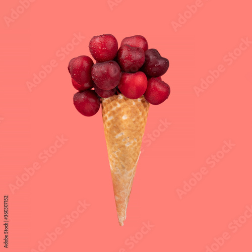 Fruits in ice cream cone isolated on red background