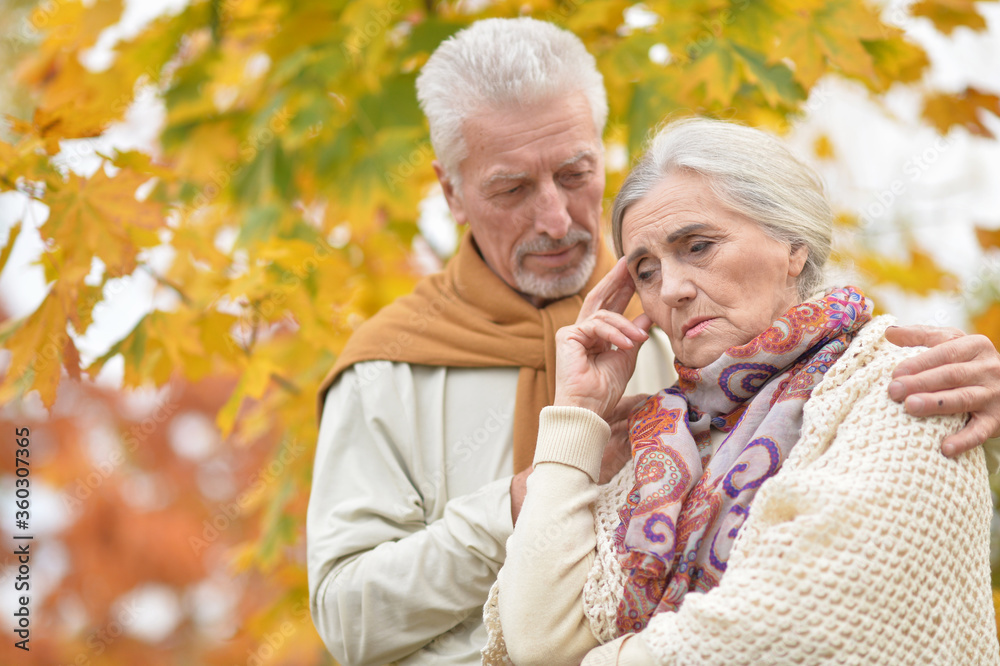 Portrait of sad senior couple in autumn park Portrait of sad senior couple in autumn park