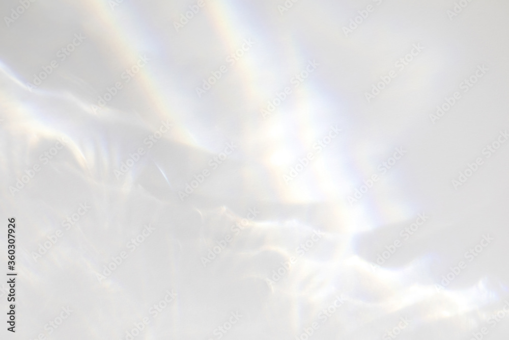 Obraz premium Blurred overlay effect for photo and mockups. Wall texture with organic drop diagonal shadow and rays of light on a white wall. shadows for natural light effects