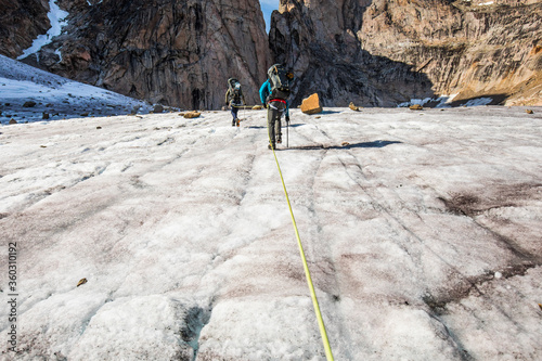 Climbers approaching mountain summit, Baffin Island.