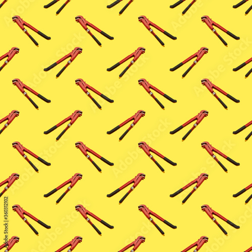 A monkey wrench seamless pattern on the yellow background. background backdrop. texture for design.