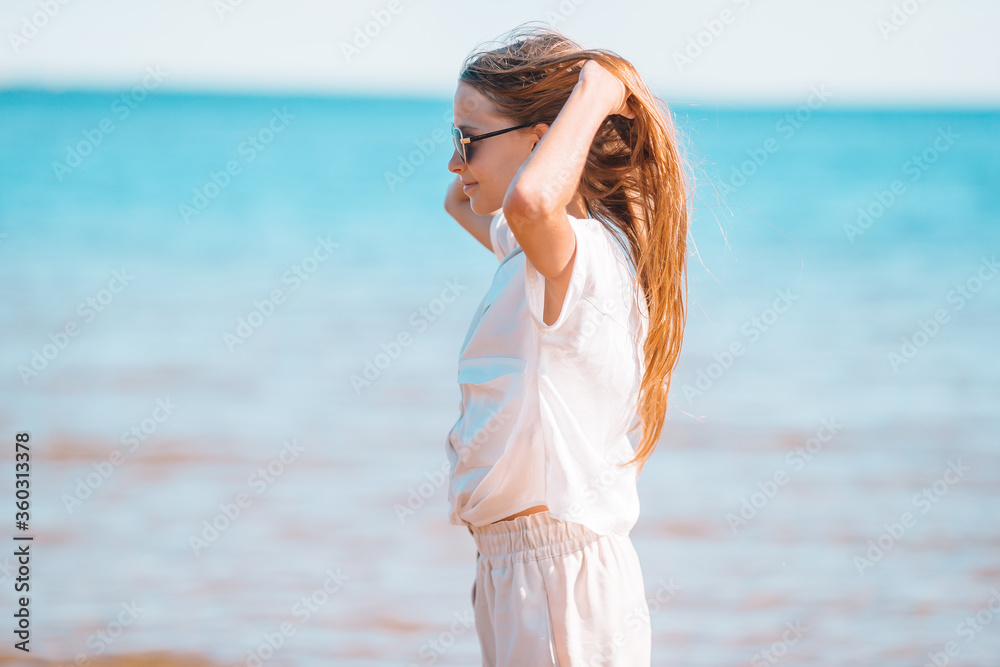 Adorable little girl at beach during summer vacation Adorable little girl at beach during summer vacation