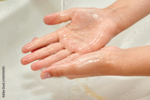 washing children's hands under the tap. No COVID-19 