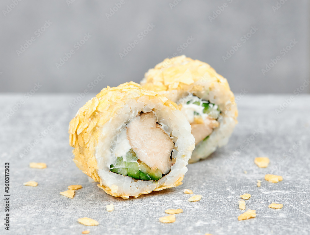 2 slices of sushi rolls uramaki with chicken, cucumber, cheese, almond 2 slices of sushi rolls uramaki with chicken, cucumber, cheese, almond