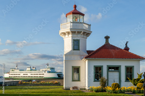 Victorian-style Mukilteo Lighthouse and docked ferry on Pacific Northwest coast, Washington state, USA photo
