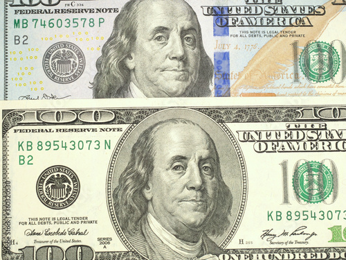 Comparing old and new one hundred dollar banknotes, closeup