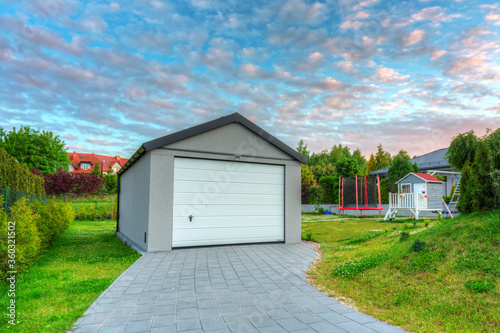 Free standing garage in the garden at sunset