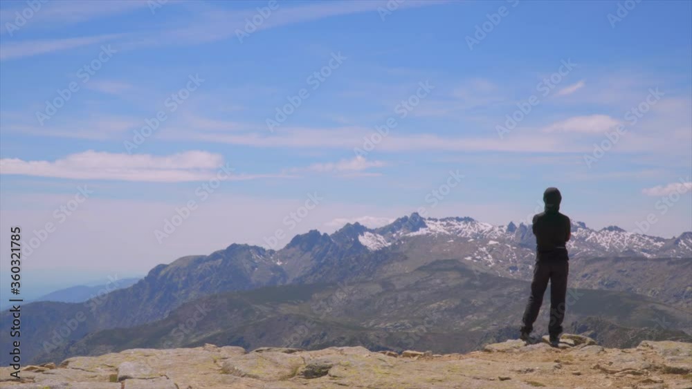 Hiker admires the crest of the snowy mountain Hiker admires the crest of the snowy mountain
