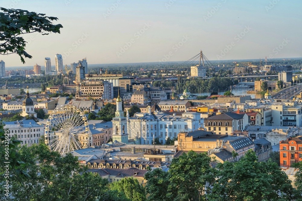 Kyiv skyline, panorama view of the city and river, bridge. Green trees, Ferris wheel, and old cathedrals. Kyiv/Kiev Ukraine. 
