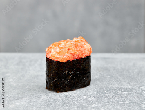 one slice shushi gunkan with salmon, spicy sauce, cucumber, rice, nori photo