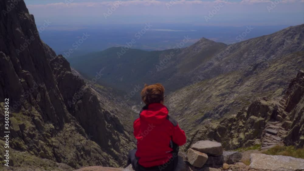 Woman rests and enjoys the view of the valley