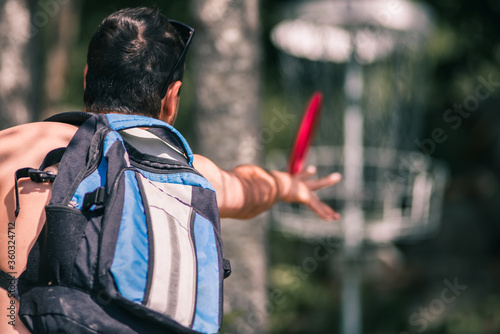 Disc Golf Man Throws Putter Frisbee at Target