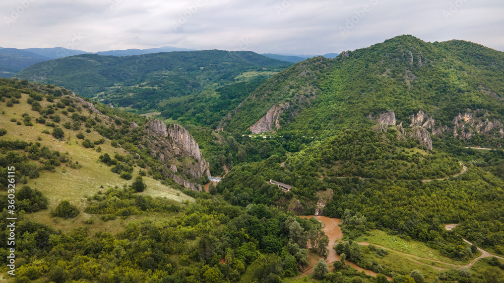 Naklejka premium Aerial shot drone image on mountains with rocks and trees and Timok river around - Baranica near Knjazevac in eastern Serbia on Balkans - nature background no people in summer day