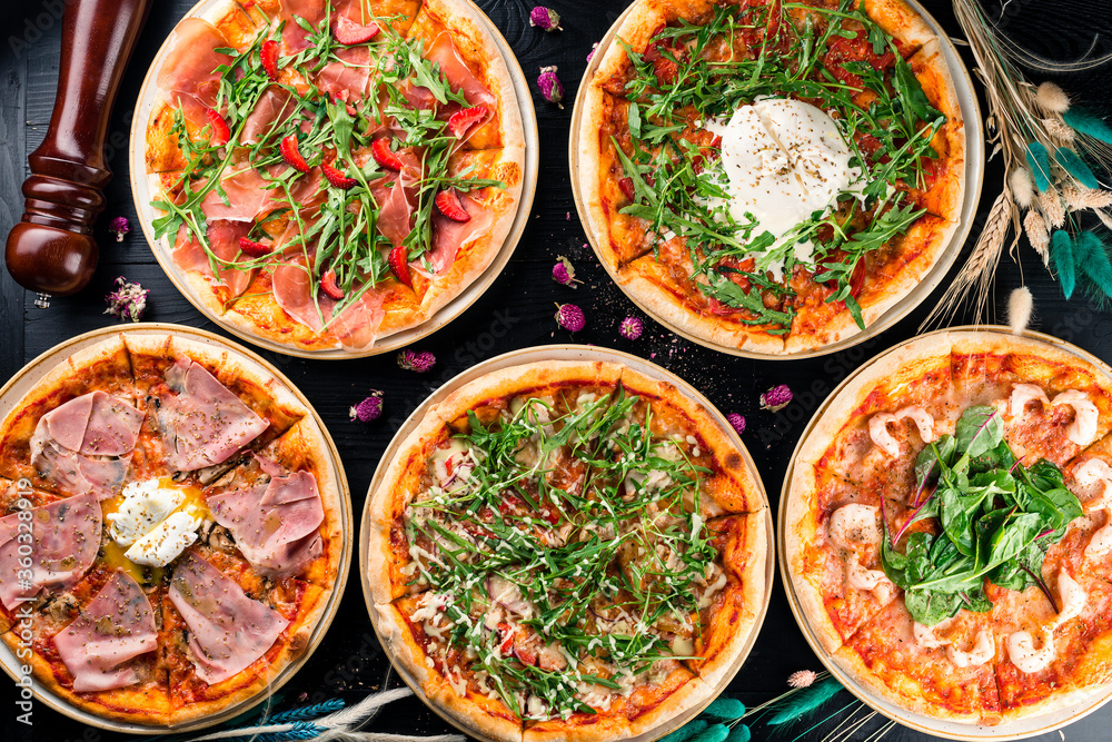 different pizzas on the set table different pizzas on the set table