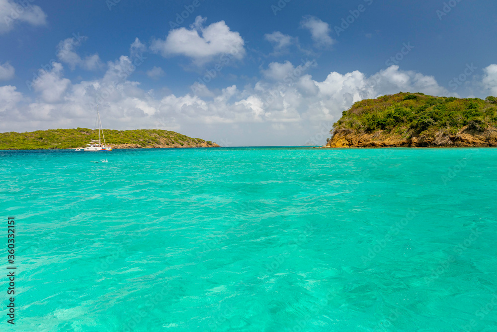 Seascape with turquoise blue water and sky with puffy clouds, islands in the Caribbean Ocean Seascape with turquoise blue water and sky with puffy clouds, islands in the Caribbean Ocean