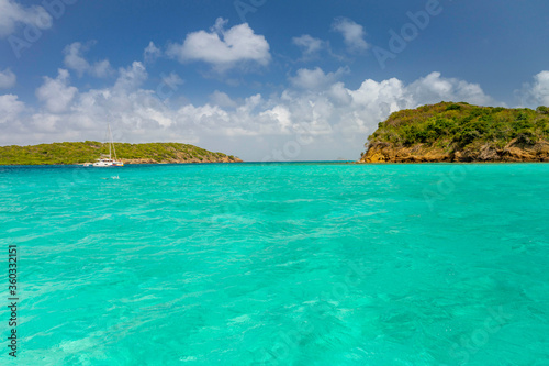  Seascape with turquoise blue water and sky with puffy clouds, islands in the Caribbean Ocean