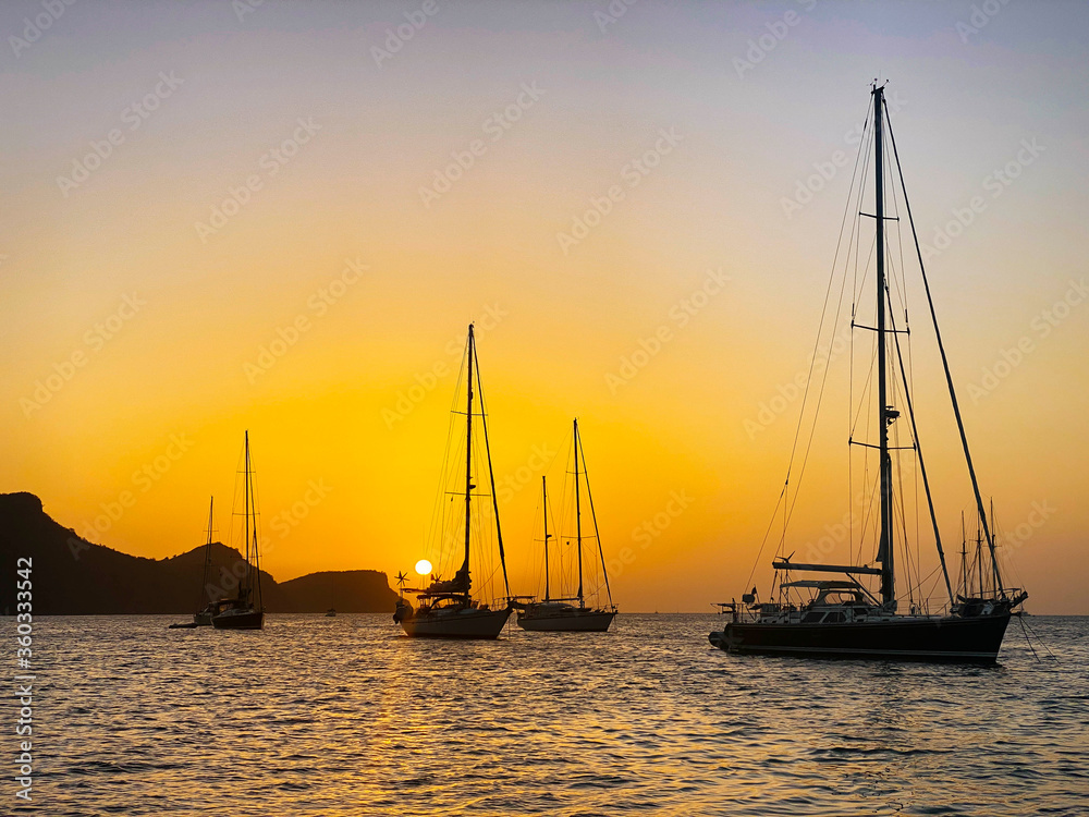 Sail boats at sunset in the bay of Bequia Island, Caribbean 