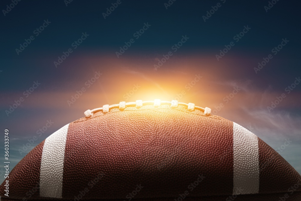 Fototapeta premium American leather football ball on sky background