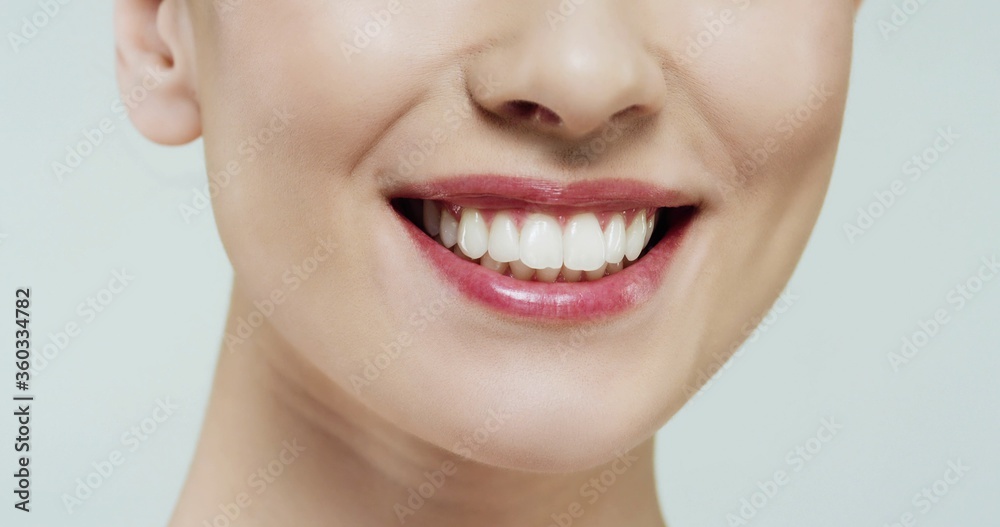 Close up cropped half face portrait of smiling model girl with healthy white teeth. Stomatology concept, strong white teeth Close up cropped half face portrait of smiling model girl with healthy white teeth. Stomatology concept, strong white teeth